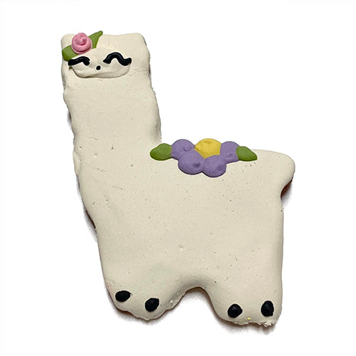 A box of adorable llama-shaped cookies made with peanut butter, featuring a yogurt coating and colorful vegetable coloring.