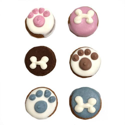 A colorful assortment of Little Bites dog biscuits, shaped in bite-size pieces, featuring peanut butter flavor and topped with yogurt coating.