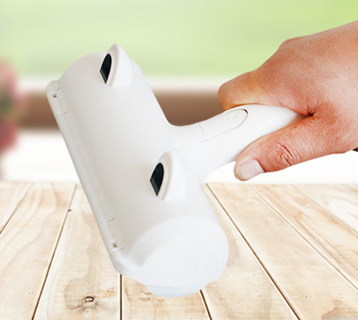 White lint roller designed for removing pet hair from furniture and clothing, featuring a compact size and durable plastic material.