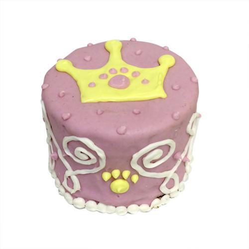 Princess Baby Cake for dogs, a peanut butter apple flavored treat, displayed in a box, showcasing its chewy texture and dark edges.