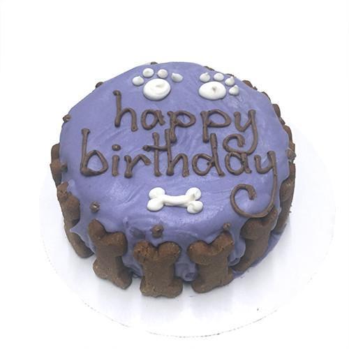 A beautifully decorated Purple Dog Cake featuring a soft peanut butter banana base and a hard yogurt coating, perfect for celebrating your dog's special day.