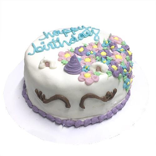 A colorful Unicorn Dog Cake decorated with yogurt coating, featuring a magical unicorn design, perfect for celebrating special occasions for dogs.