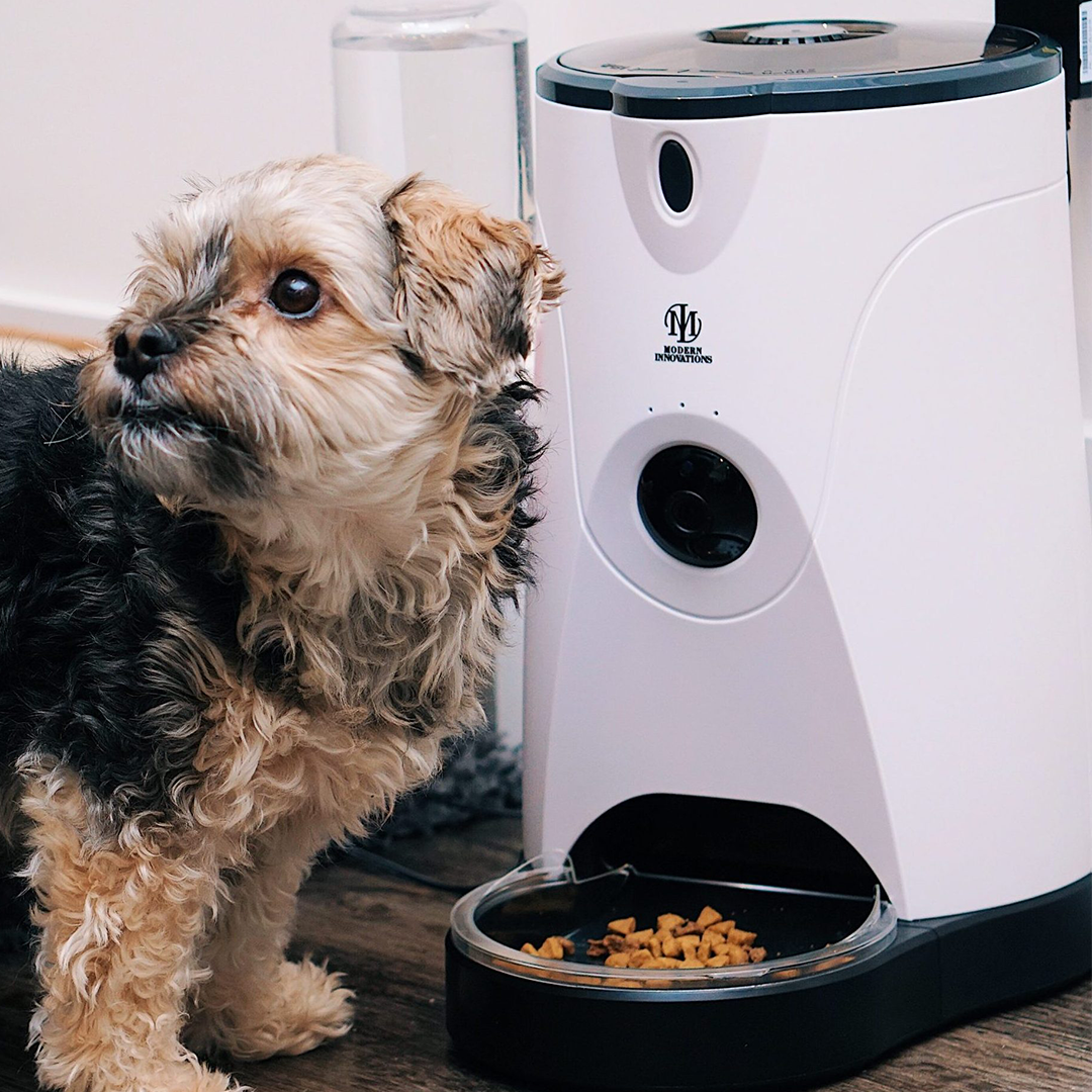 WiFi Pet Feeder with built-in camera and water feeder attachment in blue and pink options.