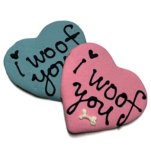 Woof Hearts peanut butter dog treats in a heart shape, featuring a yogurt coating and vibrant vegetable coloring.