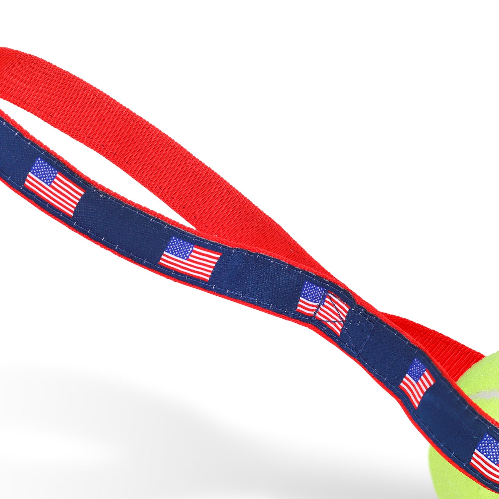 American Flag Tennis Ball Toss Toy featuring a durable nylon handle and a non-pressurized Tuff Ball, perfect for interactive play with dogs.