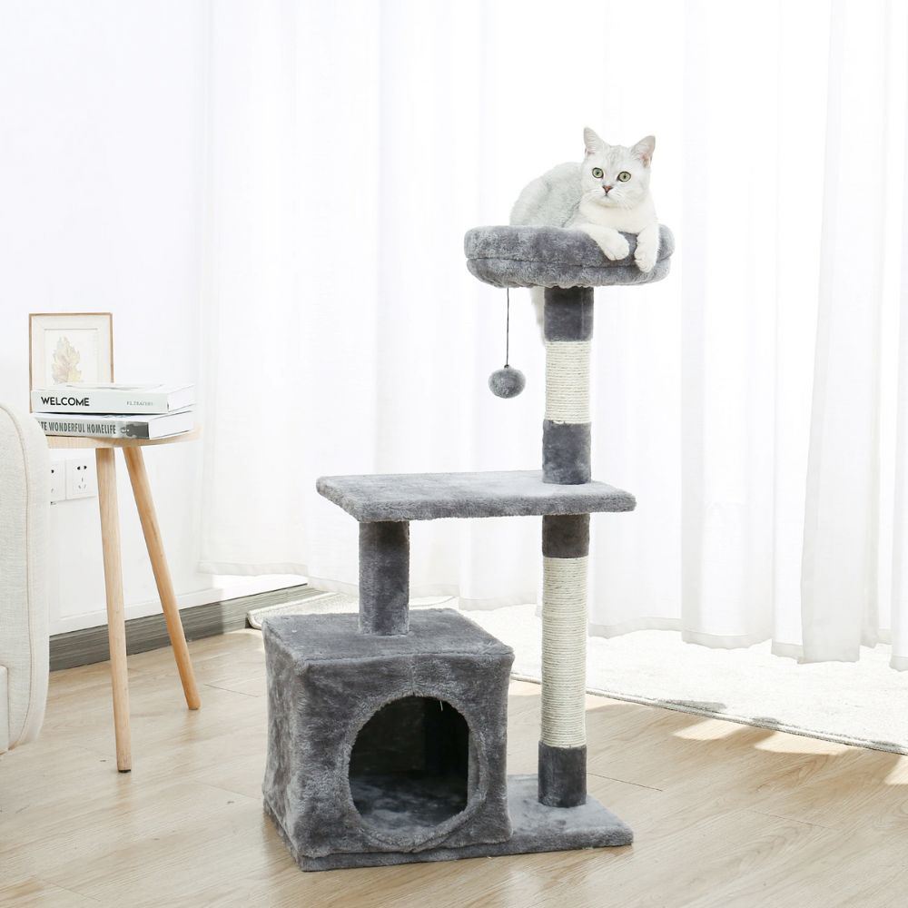 A multi-tiered cat tree house featuring scratching posts and resting areas, designed for playful cats.