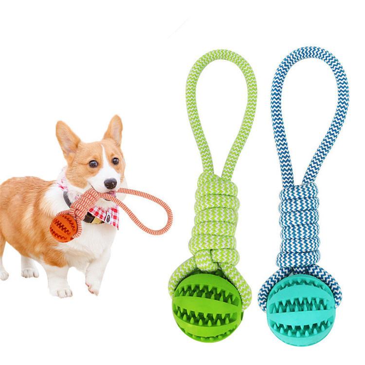 Durable rubber ball chew toy with cotton rope, designed for dogs, featuring a soft texture and vibrant colors for safe chewing and interactive play.