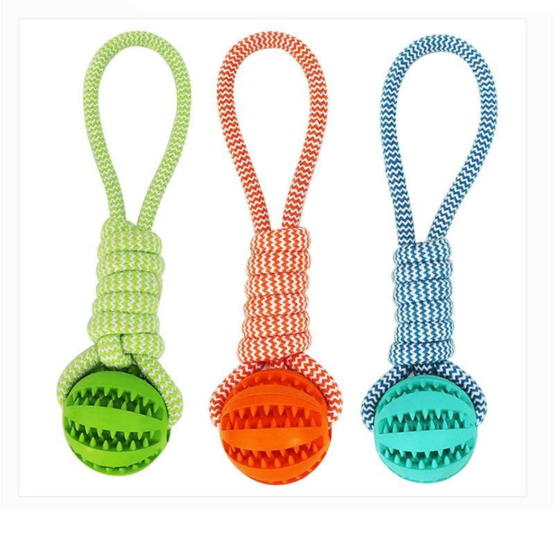 Durable rubber ball chew toy with cotton rope, designed for dogs, featuring a soft texture and vibrant colors for safe chewing and interactive play.