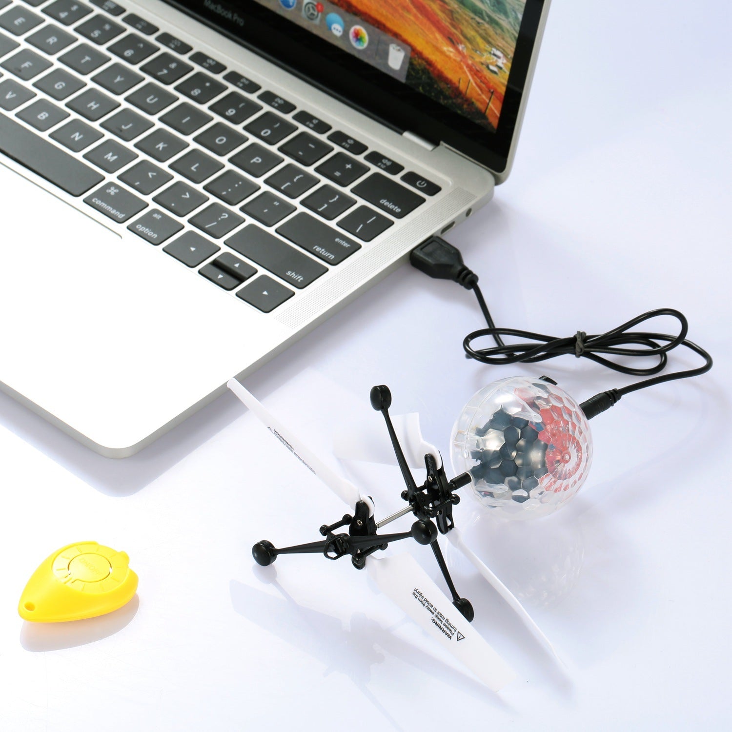 RC Flying Balls Electric Infrared Induction Drone Helicopter Ball LED with colorful lights in mid-air, showcasing its design and features.