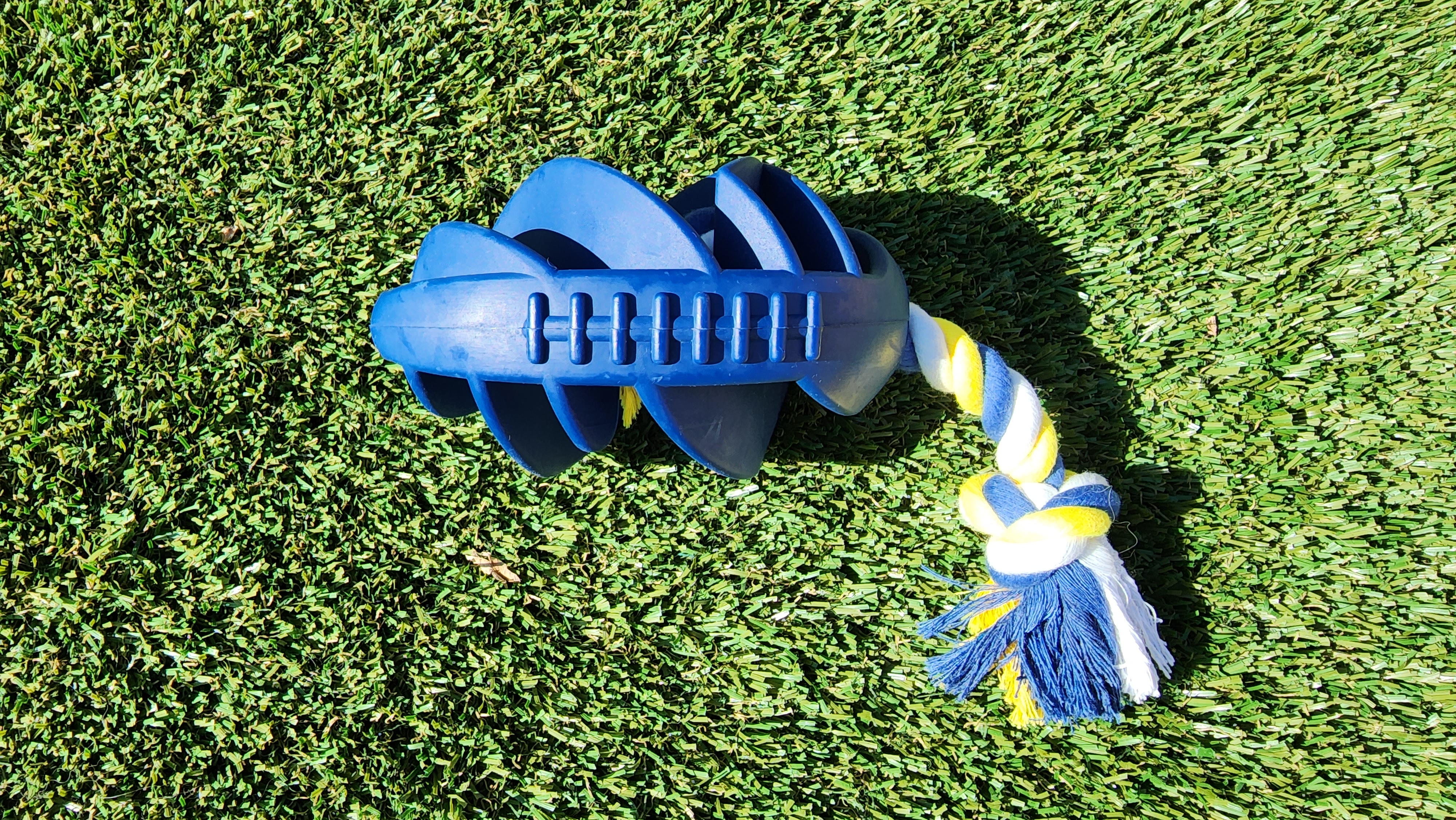 Rubber Football Dog Chew Toy with Tug Rope, featuring a durable rubber body and a sturdy rope for interactive play.