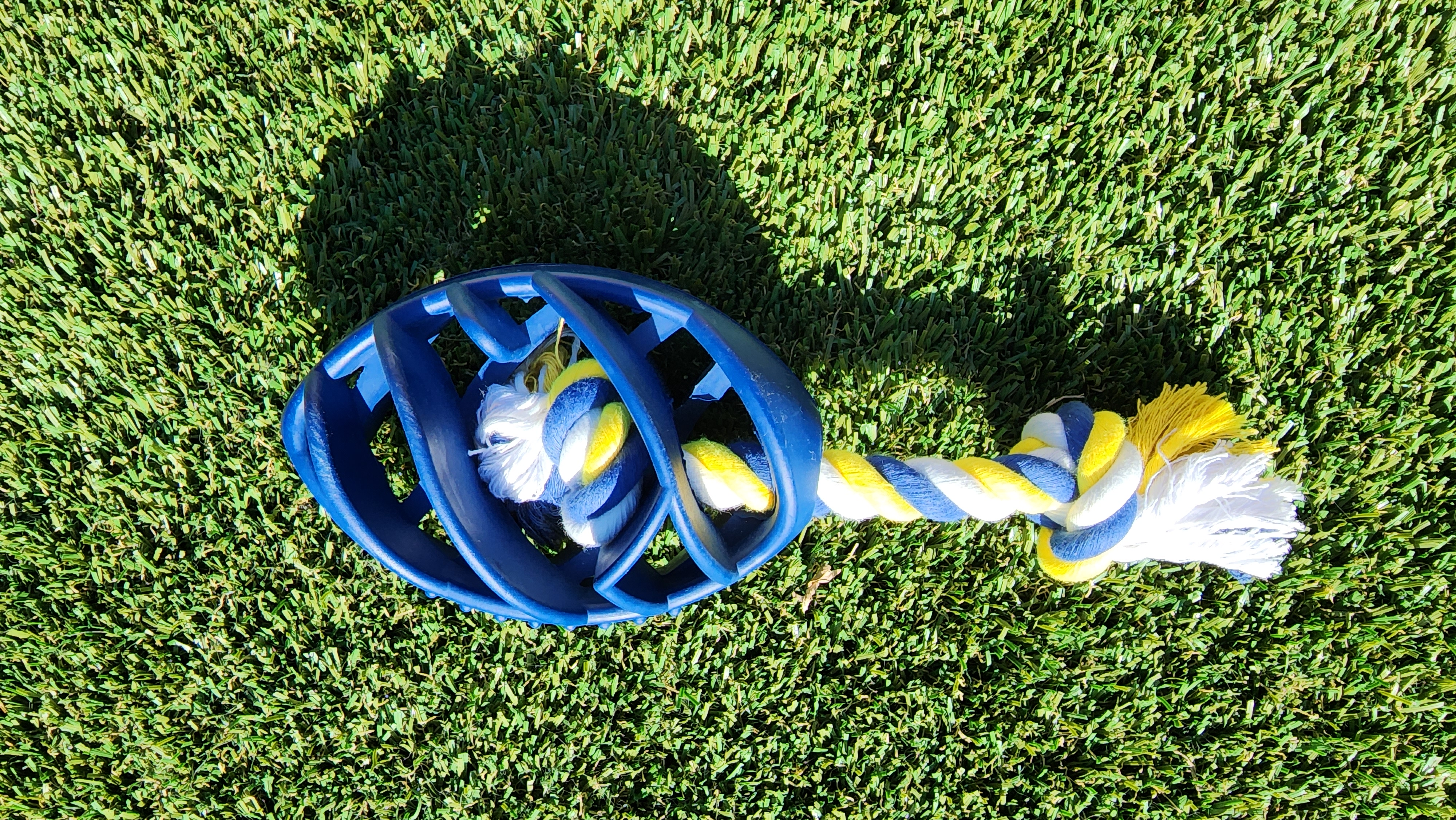 Rubber Football Dog Chew Toy with Tug Rope, featuring a durable rubber body and a sturdy rope for interactive play.