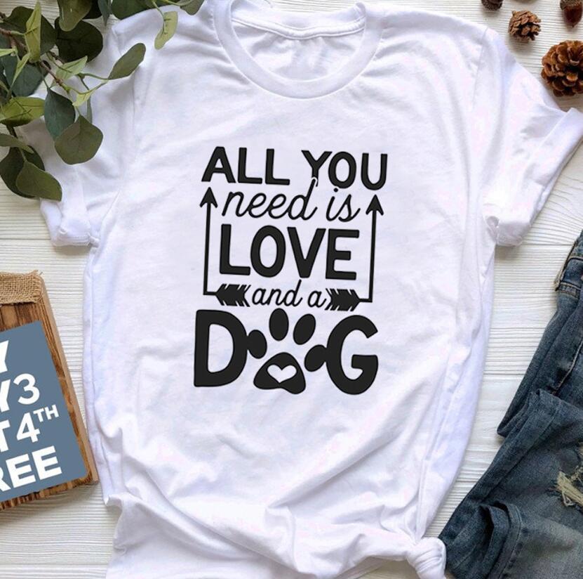 A soft unisex crewneck tee featuring the phrase 'All You Need Is Love And A Dog', perfect for dog lovers and fur mamas.