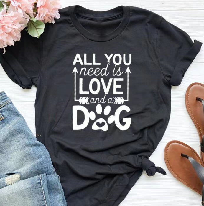 A soft unisex crewneck tee featuring the phrase 'All You Need Is Love And A Dog', perfect for dog lovers and fur mamas.