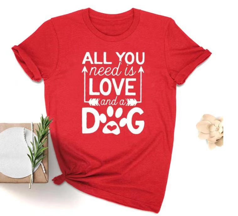 A soft unisex crewneck tee featuring the phrase 'All You Need Is Love And A Dog', perfect for dog lovers and fur mamas.