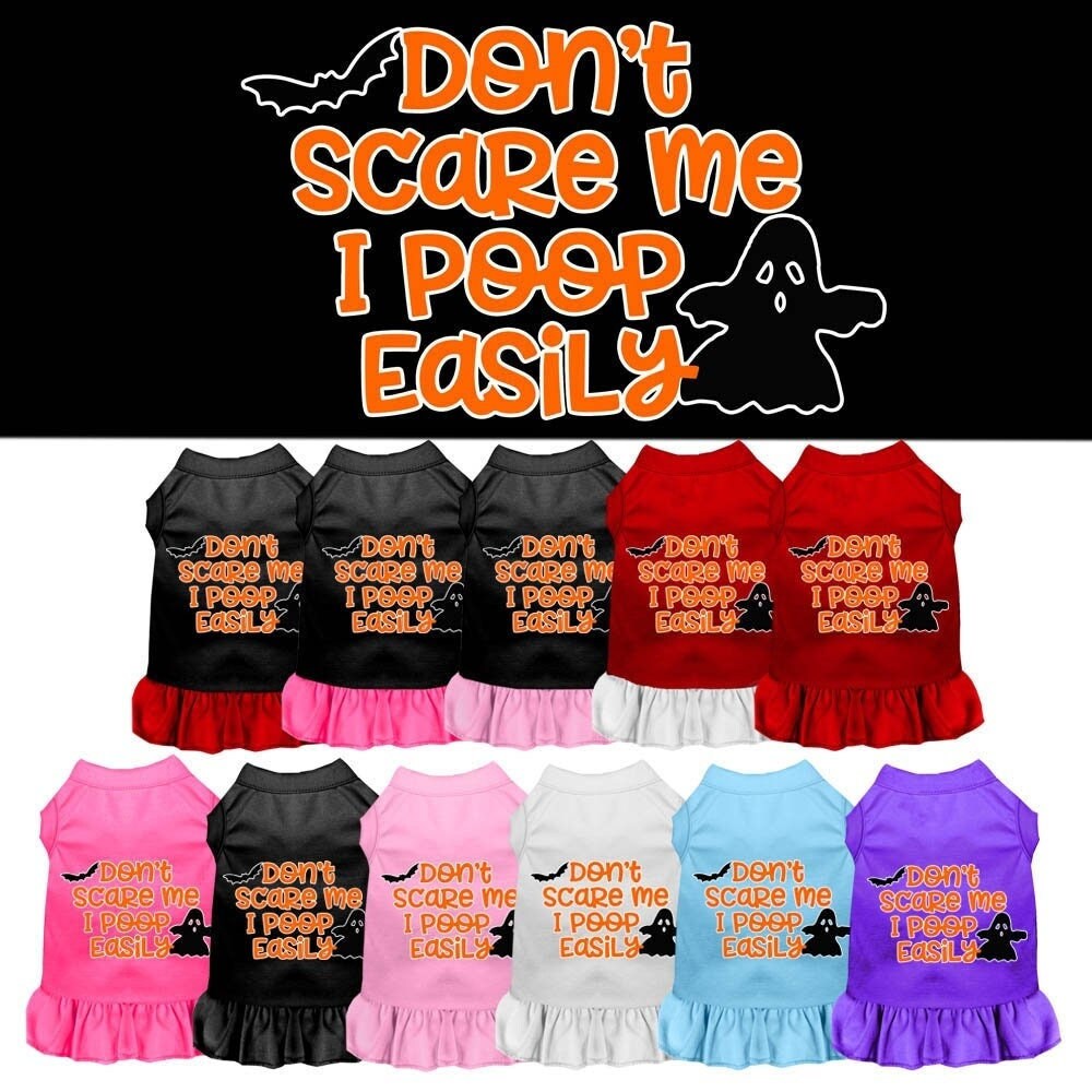 A cute dog wearing a Halloween dress with the slogan 'Don't Scare Me, I Poop Easily', showcasing a playful design perfect for pets.