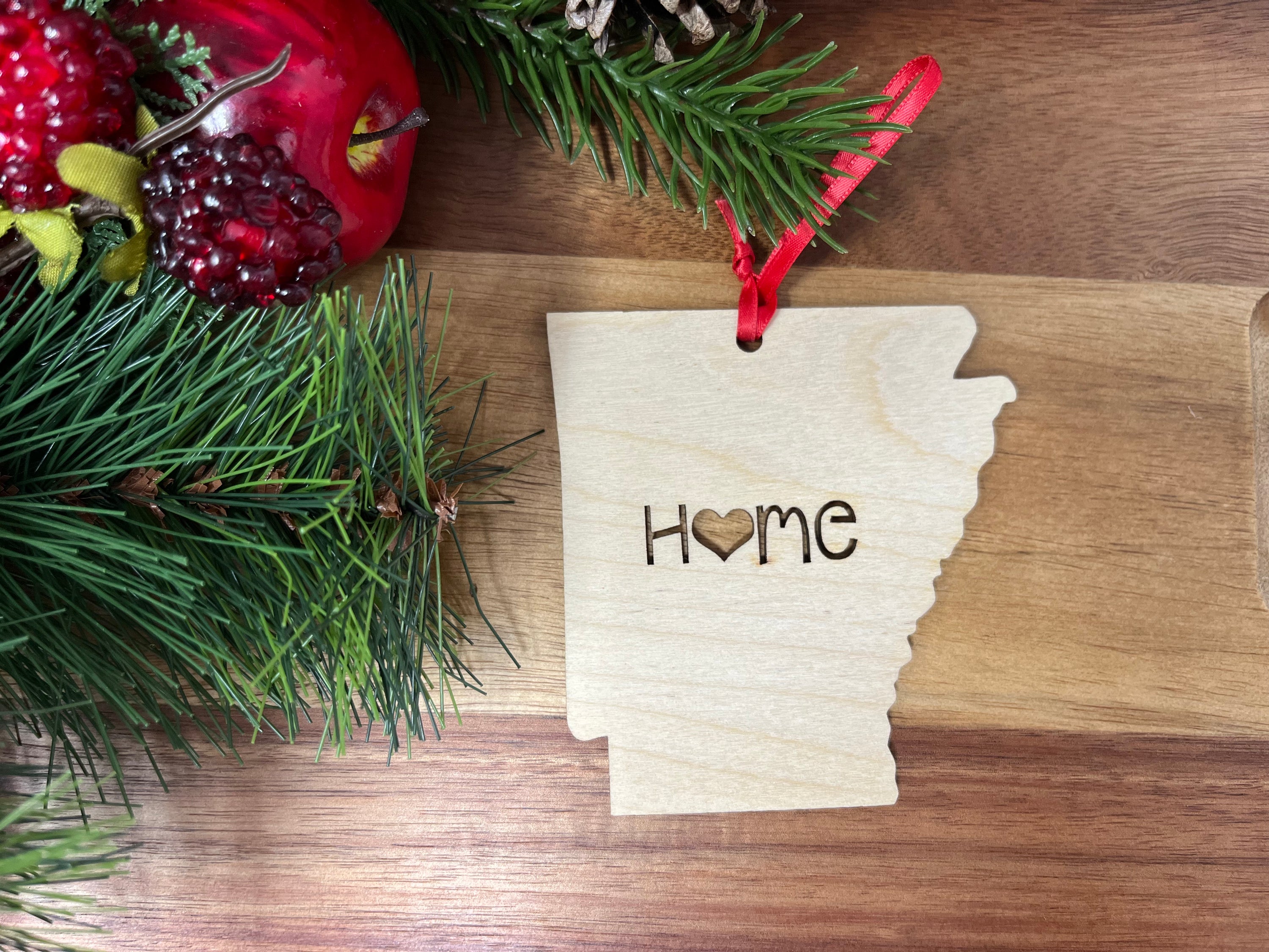 A charming Arkansas State Wood Christmas Ornament made from premium Baltic Birch, featuring the state outline and 'Home' design.