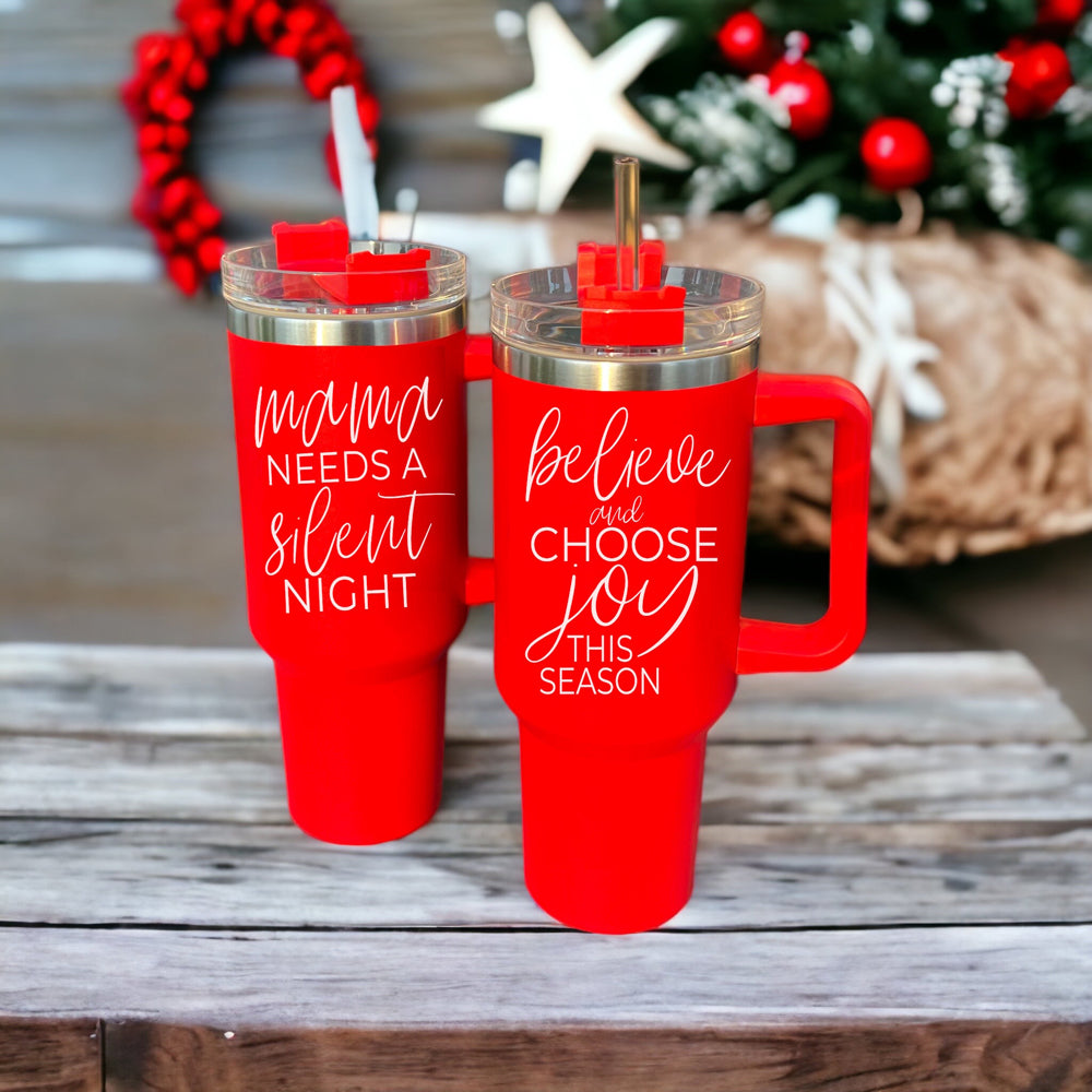 Believe + Joy 40oz insulated mug with a cheerful design and inspirational quote, featuring a lid, straw, and handle.