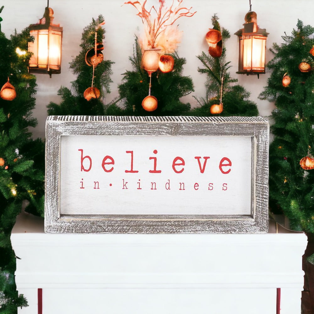 A wood framed Believe Sign featuring the phrase 'Believe In Kindness' in festive white and red colors, perfect for Christmas decor.