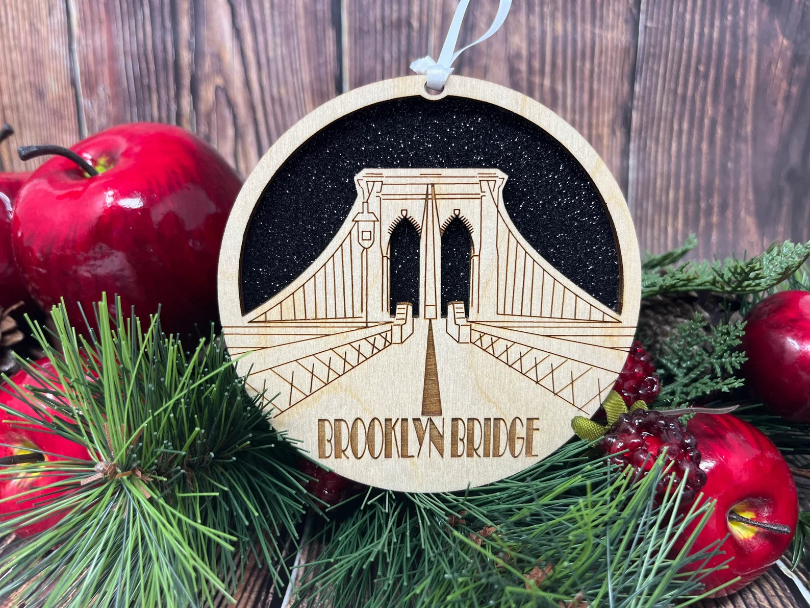 A beautifully crafted Brooklyn Bridge Ornament made from premium Baltic birch wood, showcasing intricate skyline details.