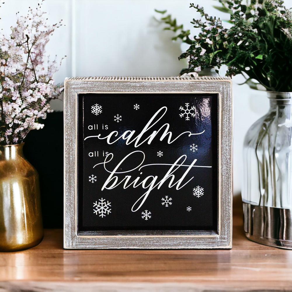 A stylish 7-inch wooden framed sign with embossed lettering that reads 'All is calm all is bright', perfect for holiday decor.