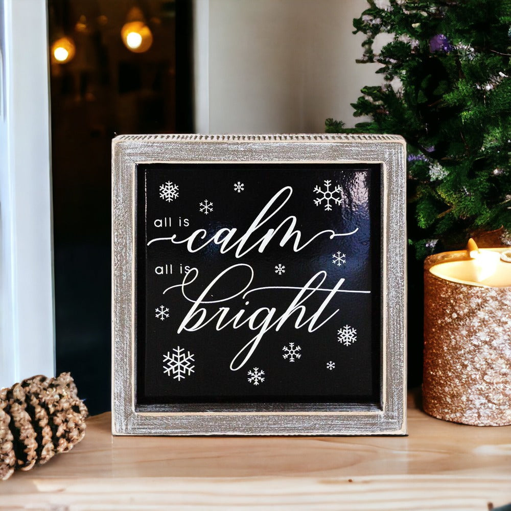 A stylish 7-inch wooden framed sign with embossed lettering that reads 'All is calm all is bright', perfect for holiday decor.