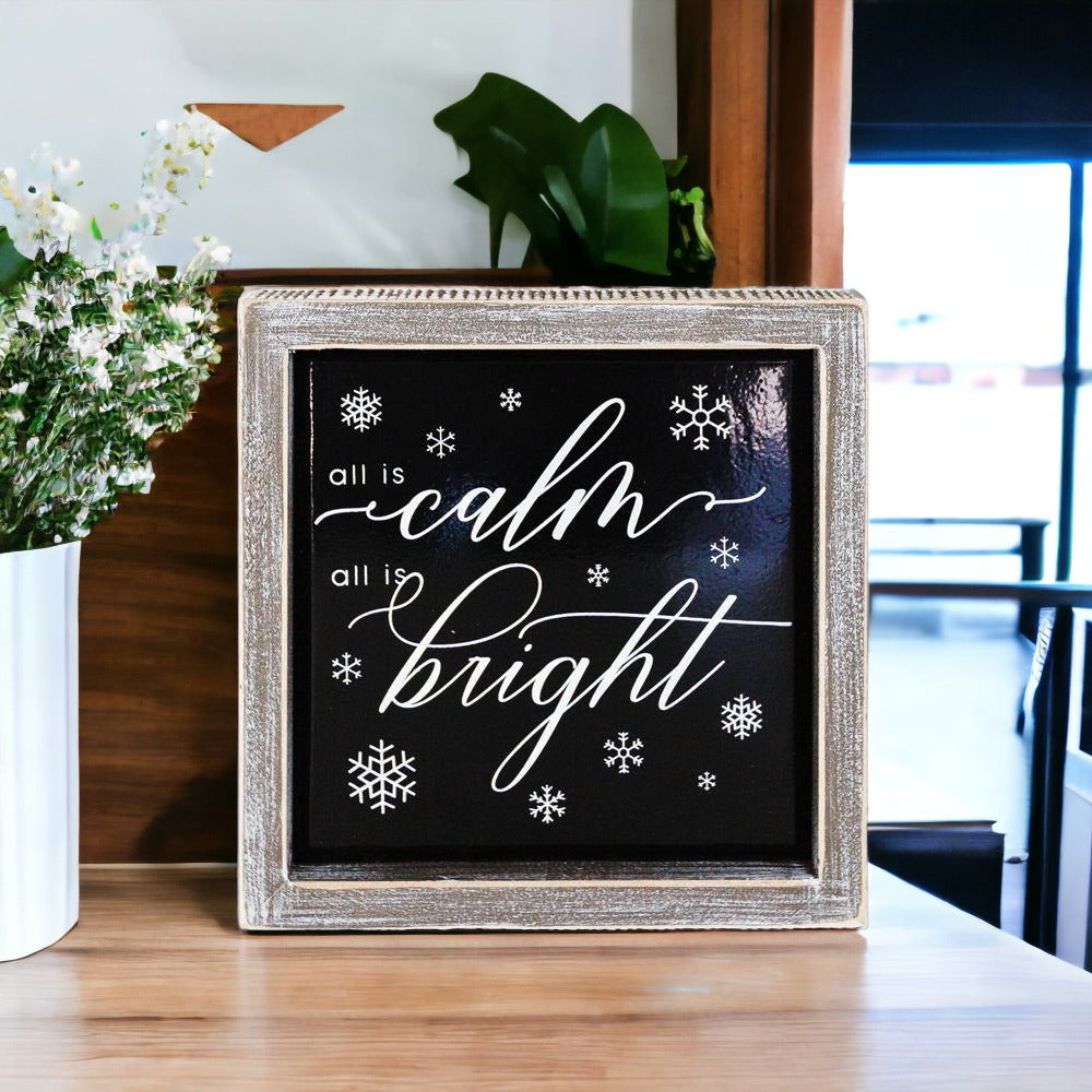 A stylish 7-inch wooden framed sign with embossed lettering that reads 'All is calm all is bright', perfect for holiday decor.