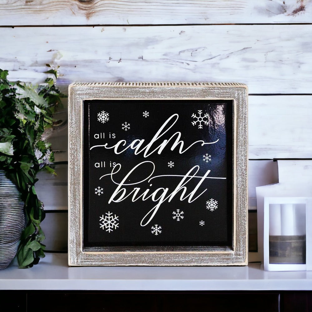 A stylish 7-inch wooden framed sign with embossed lettering that reads 'All is calm all is bright', perfect for holiday decor.