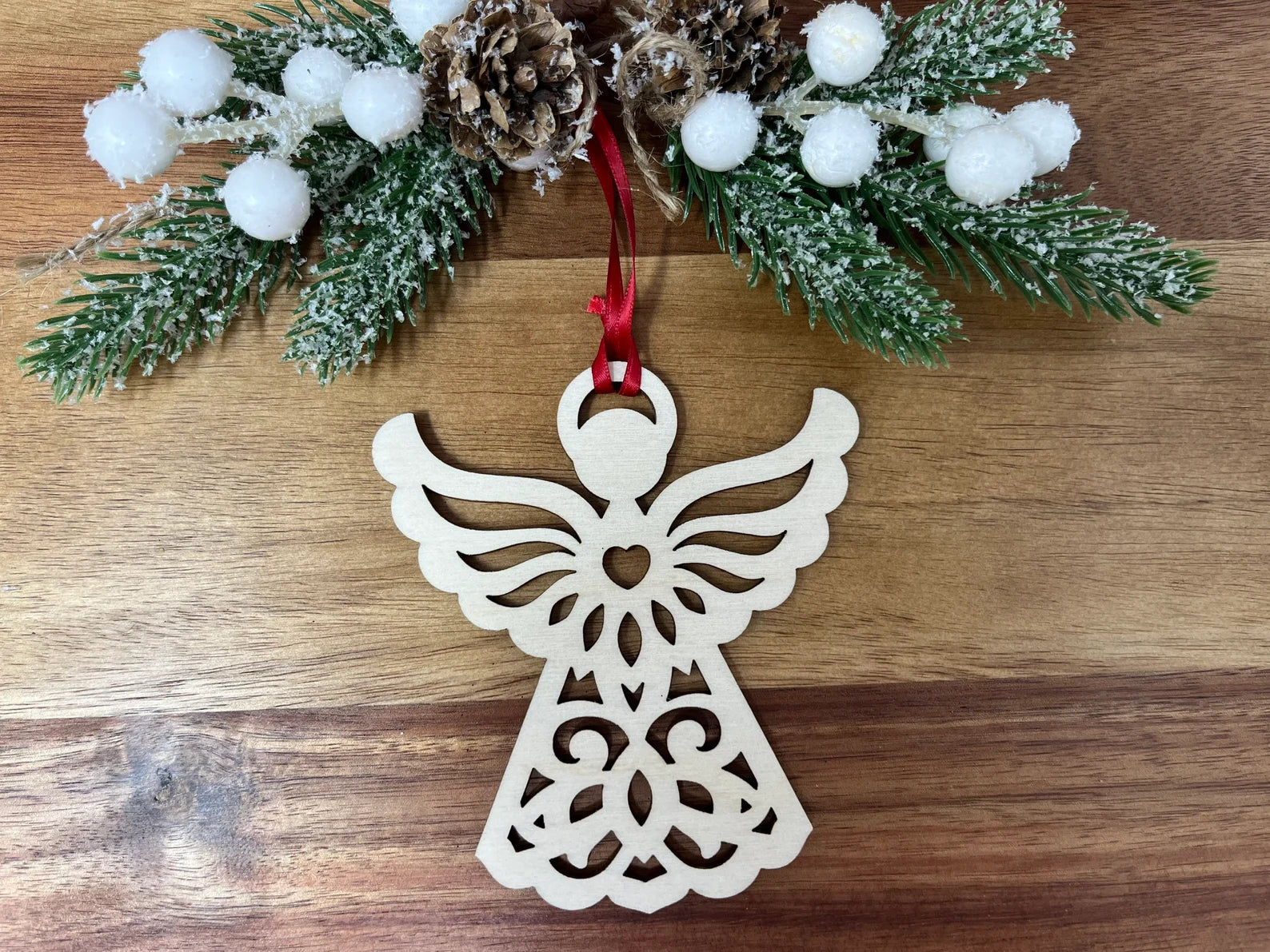 Beautifully crafted Christmas Angel ornament made from birch wood, featuring intricate designs and an elegant ribbon, packaged in a premium jewelry box.