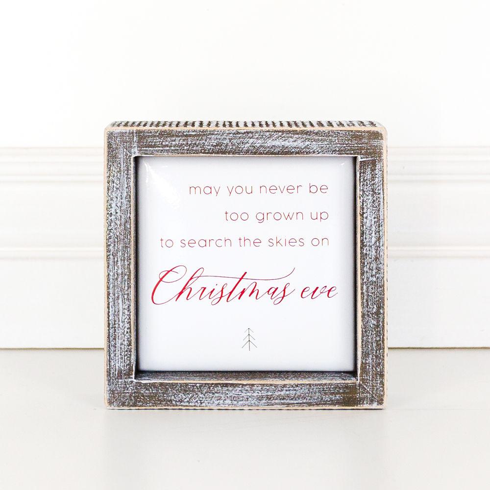 A beautifully crafted 5-inch wooden framed sign with metal embossed lettering that reads 'may you never be too grown to search the skies on Christmas eve'.