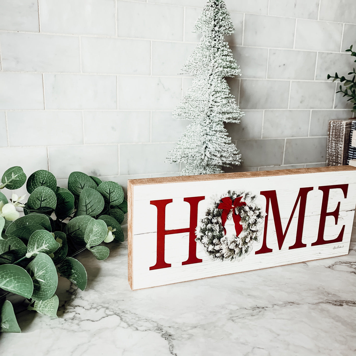 Handmade wooden Christmas Home sign with a festive wreath on the letter 'O', perfect for holiday decor.