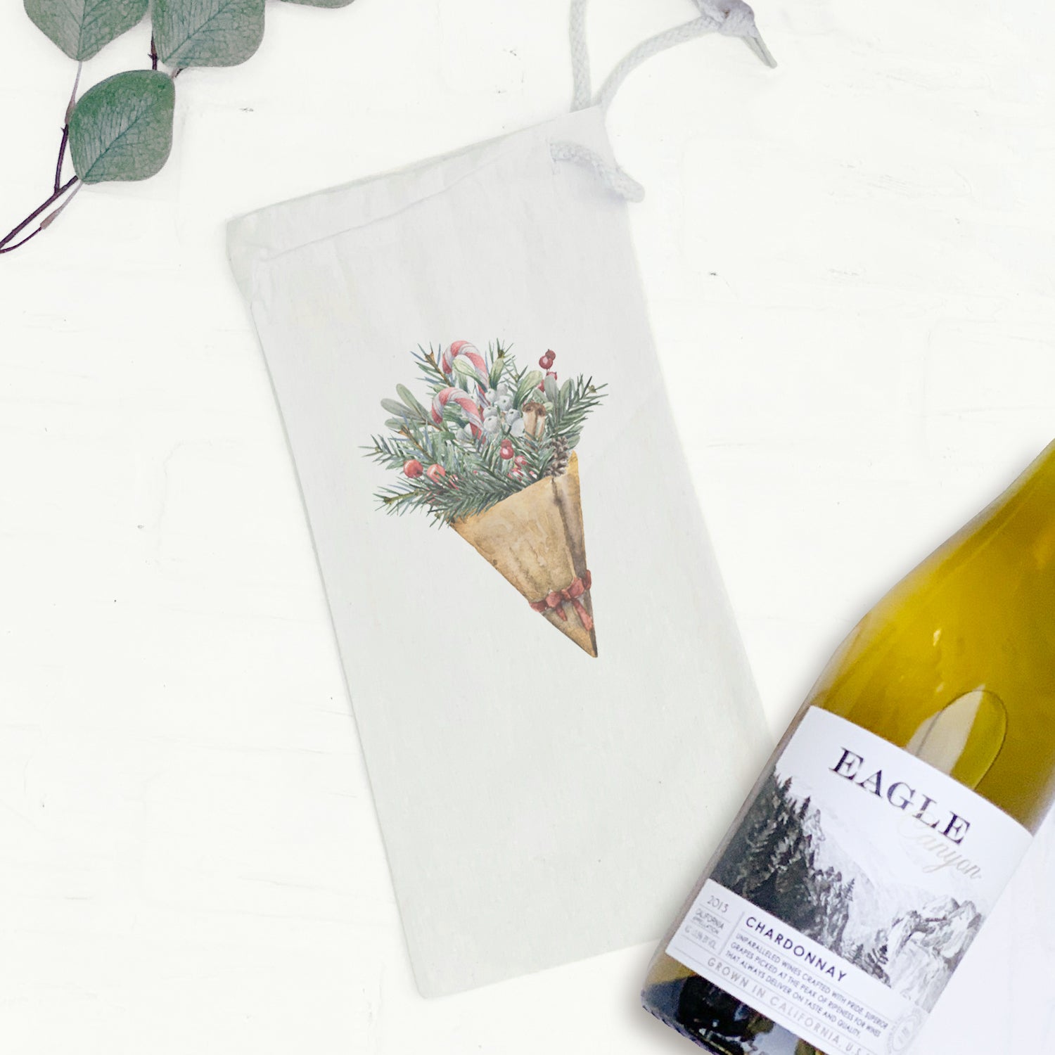 Christmas Pine Bouquet canvas wine bag featuring a festive design with a drawstring closure, perfect for gifting wine.