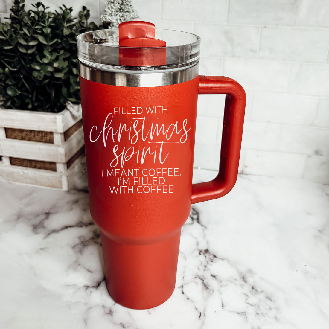 A vibrant red insulated mug with a humorous holiday quote, featuring a matte finish and a versatile 3-in-1 lid.