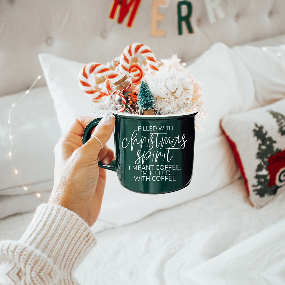 A festive Christmas Spirit Mug in red ceramic with white lettering, showcasing a cheerful design on both sides, perfect for holiday beverages.