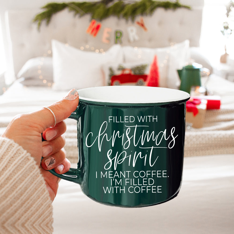 A festive Christmas Spirit Mug in red ceramic with white lettering, showcasing a cheerful design on both sides, perfect for holiday beverages.