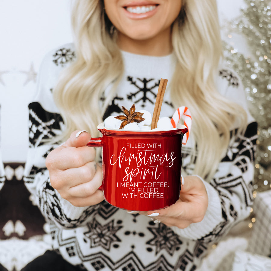 A festive Christmas Spirit Mug in red ceramic with white lettering, showcasing a cheerful design on both sides, perfect for holiday beverages.