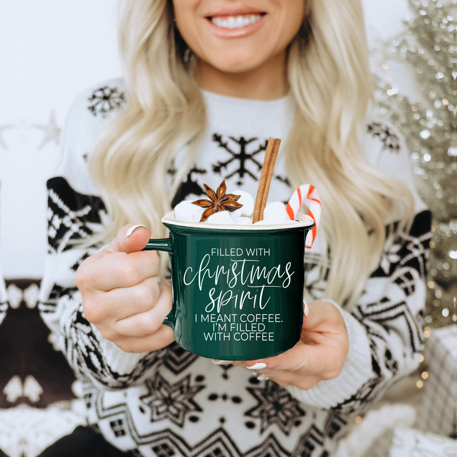 A festive Christmas Spirit Mug in red ceramic with white lettering, showcasing a cheerful design on both sides, perfect for holiday beverages.