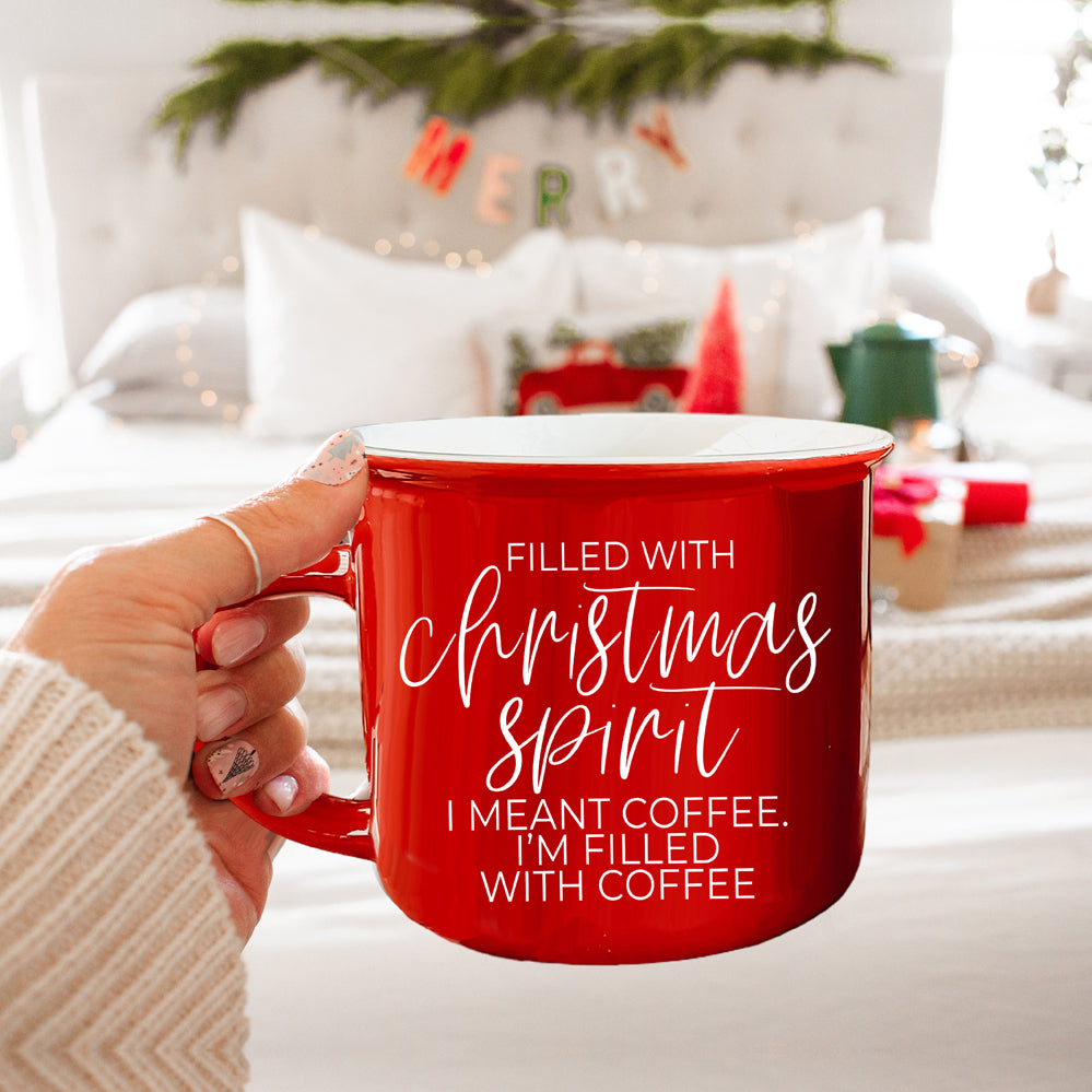 A festive Christmas Spirit Mug in red ceramic with white lettering, showcasing a cheerful design on both sides, perfect for holiday beverages.