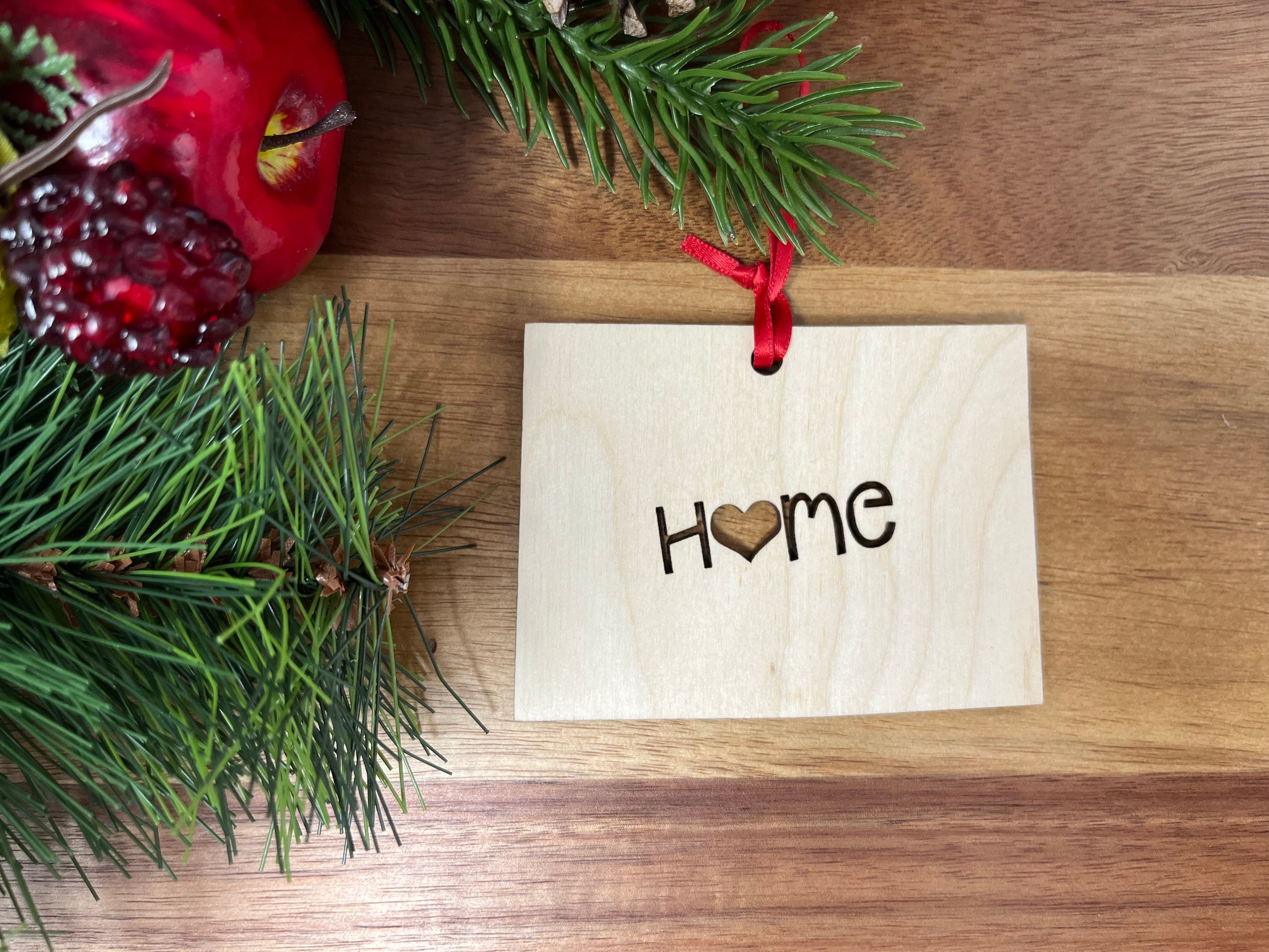 A beautifully crafted Colorado State Wood Christmas Ornament made from premium Baltic Birch wood, featuring the word 'Home' and a charming design.