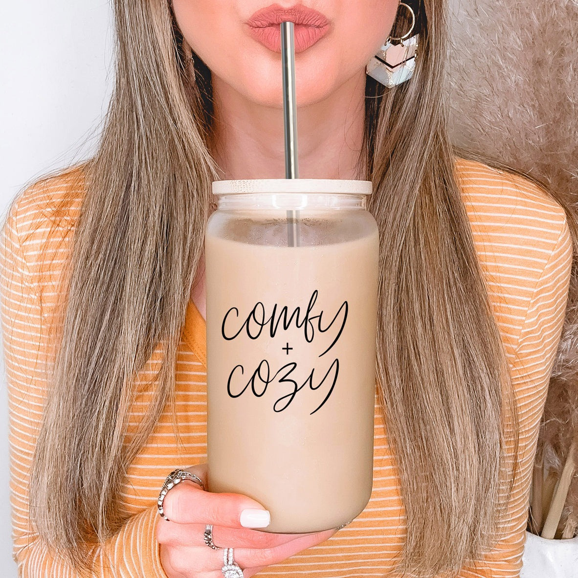 A stylish Comfy Cozy Cup made of high borosilicate glass with a bamboo lid and stainless steel straws, perfect for hot and cold beverages.