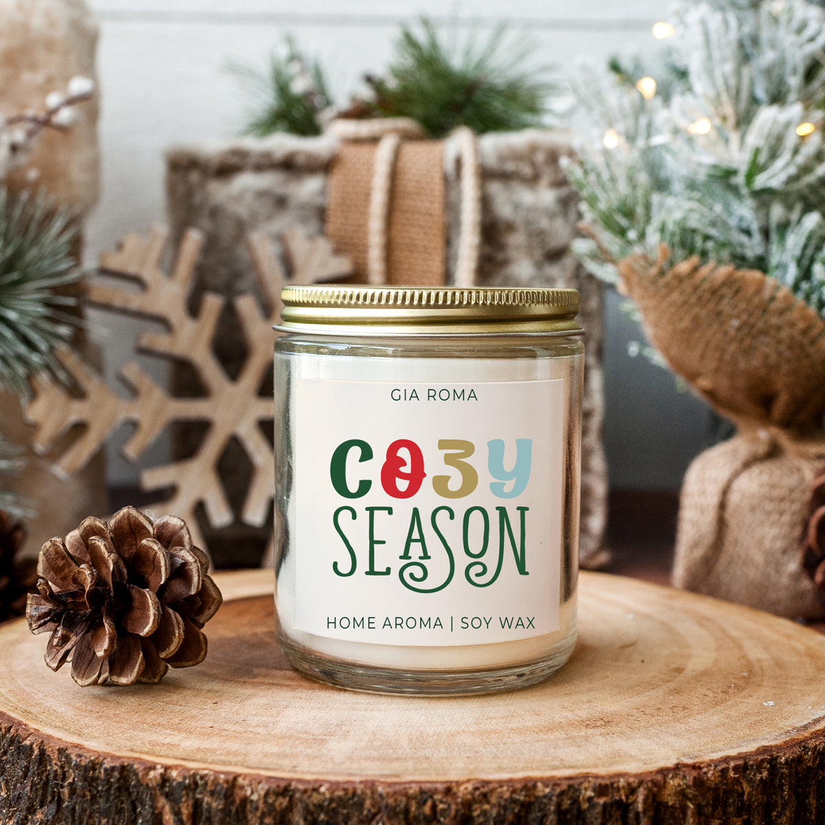 A beautifully crafted 9oz Cozy Season Candle with a warm glow, featuring a blend of winter scents like citrus, cloves, and pine cones.