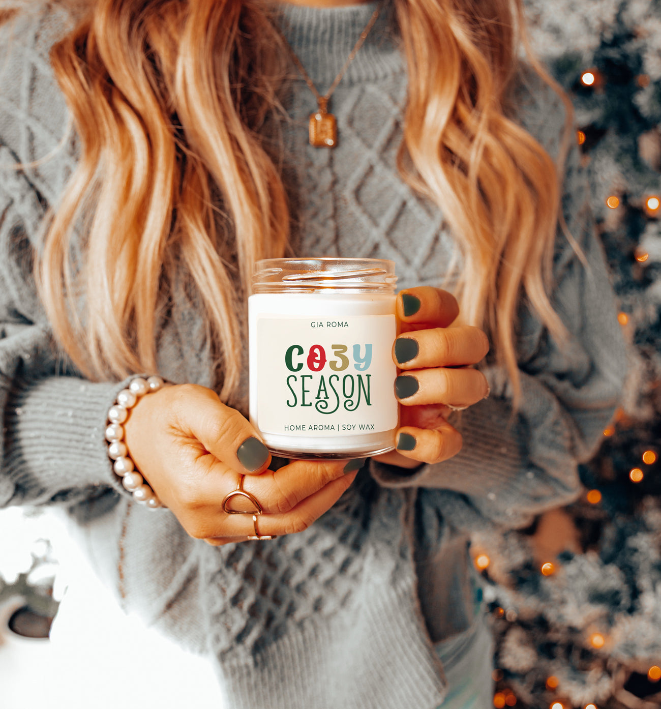 A beautifully crafted 9oz Cozy Season Candle with a warm glow, featuring a blend of winter scents like citrus, cloves, and pine cones.