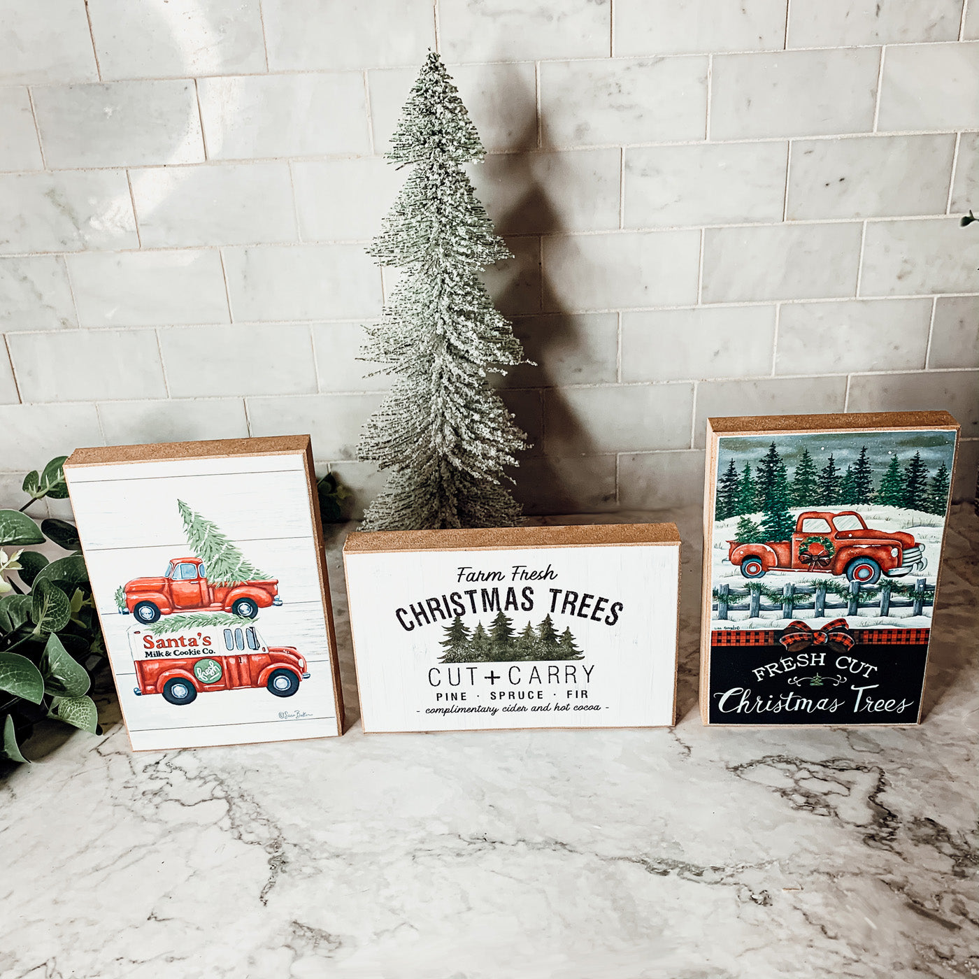 A decorative Cut + Carry Sign featuring a light gray textured background with the text about farm fresh Christmas trees and complimentary cider and hot cocoa.