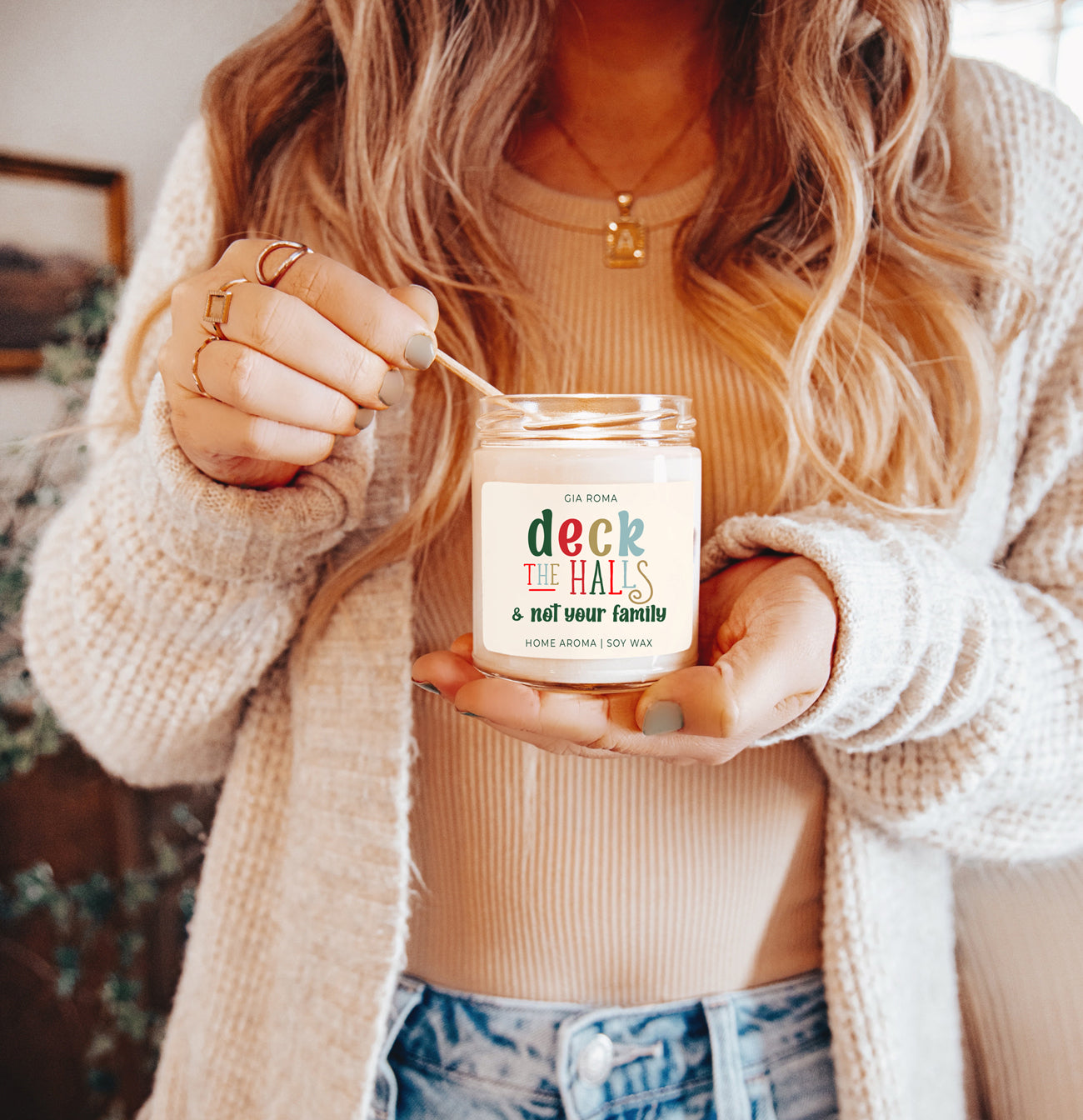 Deck The Halls Candle in a 9oz jar with festive scent notes of clove, cinnamon, berry, plum, and fir, perfect for holiday ambiance.