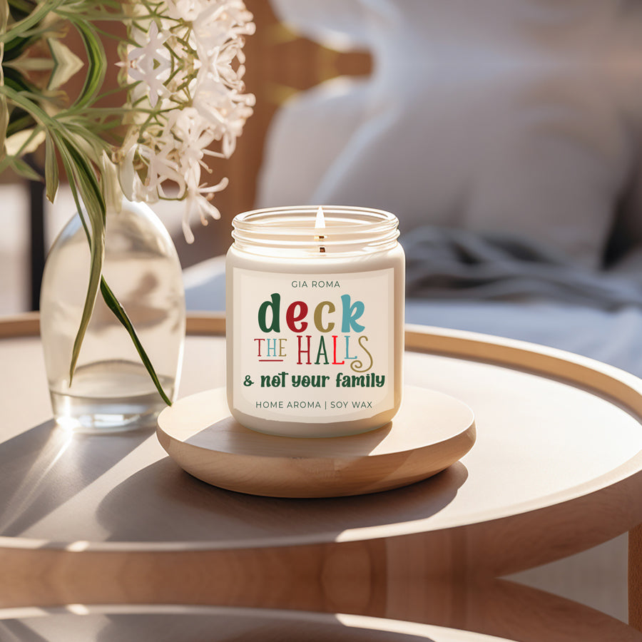 Deck The Halls Candle in a 9oz jar with festive scent notes of clove, cinnamon, berry, plum, and fir, perfect for holiday ambiance.