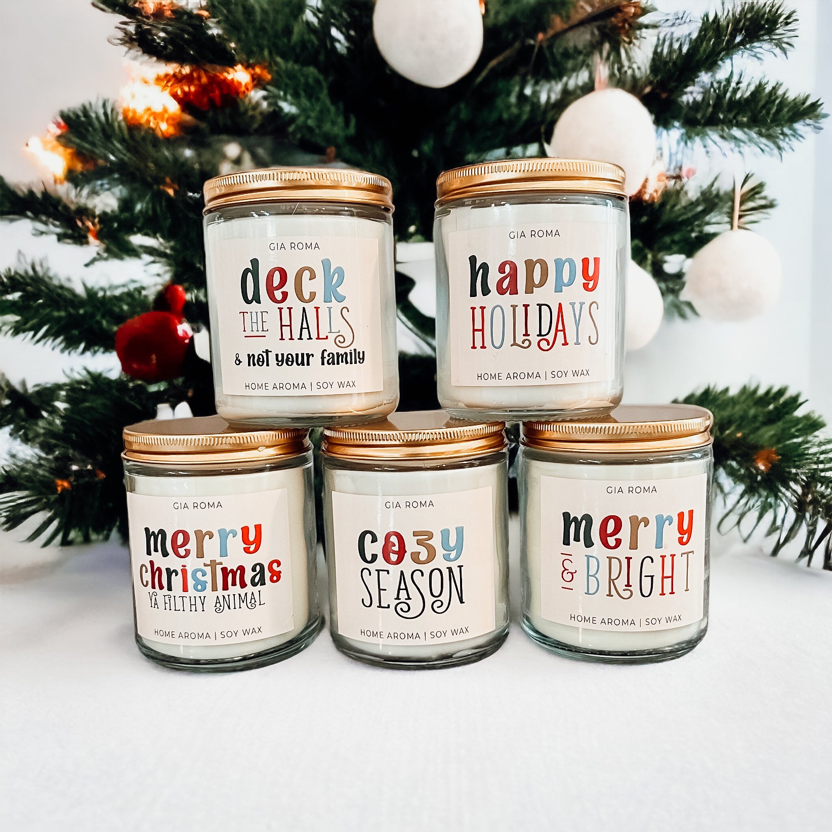 Deck The Halls Candle in a 9oz jar with festive scent notes of clove, cinnamon, berry, plum, and fir, perfect for holiday ambiance.