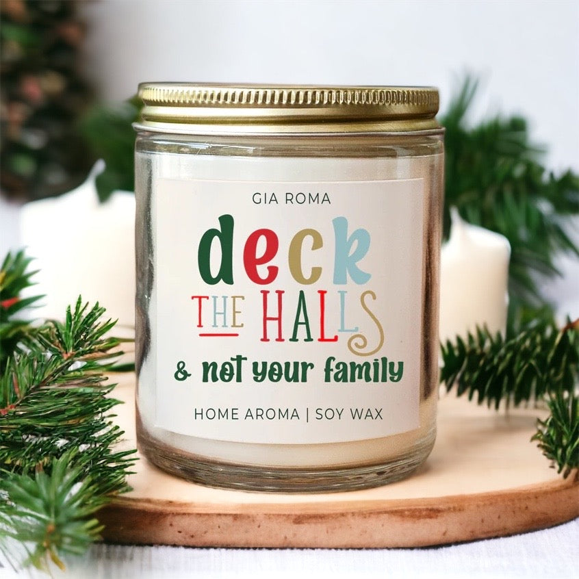 Deck The Halls Candle in a 9oz jar with festive scent notes of clove, cinnamon, berry, plum, and fir, perfect for holiday ambiance.