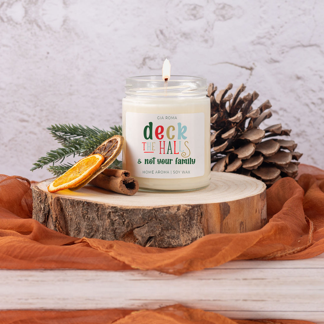 Deck The Halls Candle in a 9oz jar with festive scent notes of clove, cinnamon, berry, plum, and fir, perfect for holiday ambiance.