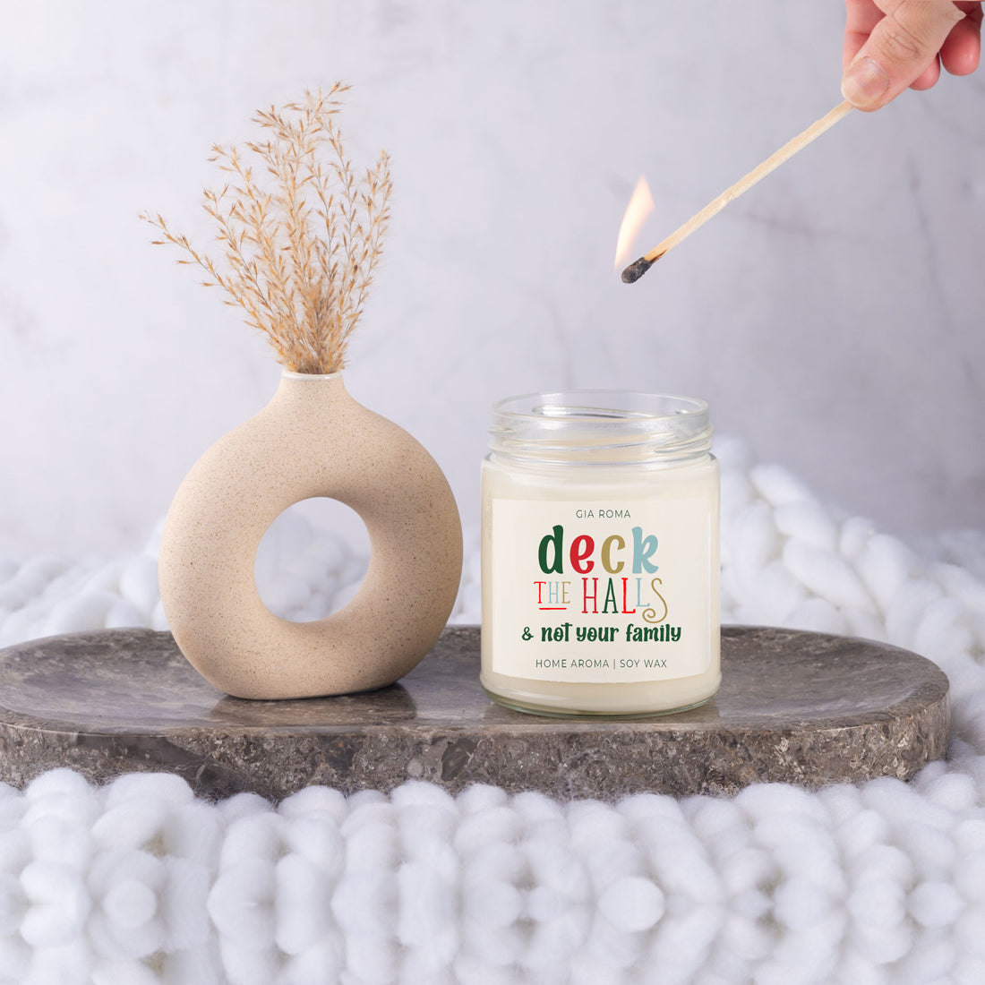 Deck The Halls Candle in a 9oz jar with festive scent notes of clove, cinnamon, berry, plum, and fir, perfect for holiday ambiance.