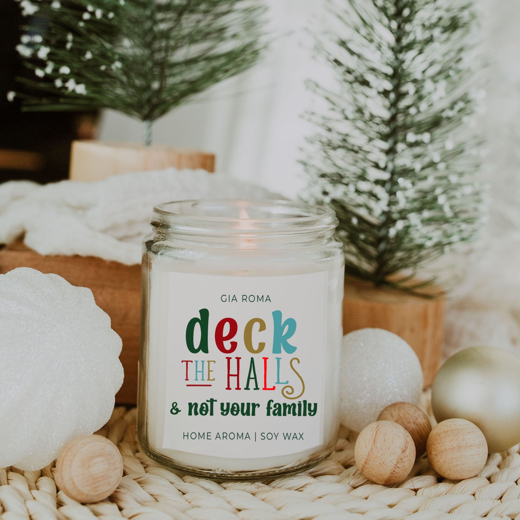 Deck The Halls Candle in a 9oz jar with festive scent notes of clove, cinnamon, berry, plum, and fir, perfect for holiday ambiance.