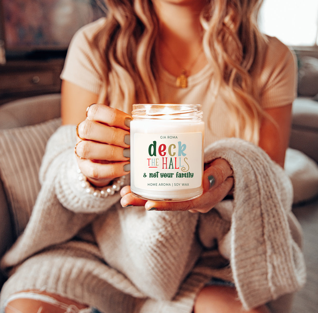 Deck The Halls Candle in a 9oz jar with festive scent notes of clove, cinnamon, berry, plum, and fir, perfect for holiday ambiance.